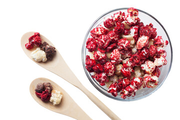 Rustic colored cups of Chocolate, Strawberry and Cream Gourmet Popcorn over white background.