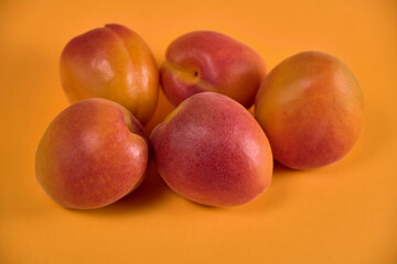 Fresh juicy apricots in a transparent glass plate. Macro.