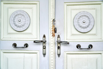 Wooden, antique door with metal door handles in the Czech Republic.