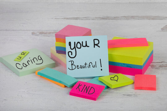 You are beautiful words of inspiring affirmation caring kind stack of piled posted notes  