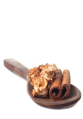 Amazing view of gourmet cinnamon and coffee popcorn with rustic utensils over a white background.