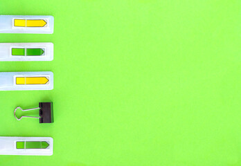 Flat lay with office or school stationery and supplies on bright green background. Top view, copy space. Back to school concept.