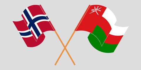 Crossed and waving flags of Oman and Norway