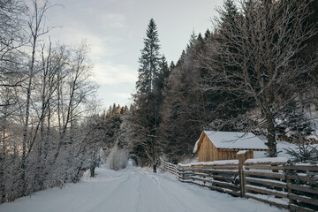 A close up of a wood fence covered in snow