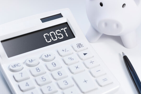 Word Cost on calculator. Business and tax concept on white background. Top view.