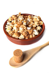 Rustic bowls with gourmet peanut candy popcorn isolated on white background.