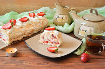Meringue cake with strawberries for tea on the table
