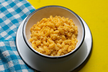 Creamy mac and cheese on yellow background