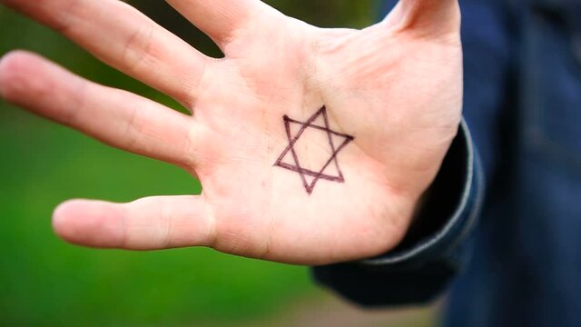 Hand with the symbol of modern Jewish identity on the palm: Star of David