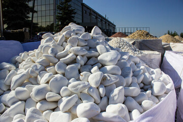 decorative river stones in a big bag outside on the street