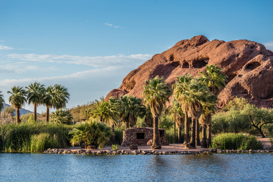 A view of the unique sandstone formation known as Hole-in-the-Rock from across a pond in Arizona's Papago Park.