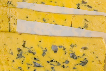 cheese sliced with mold lies flat