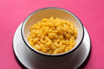 Creamy mac and cheese on pink background