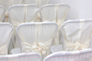 Luxurious texture of white chairs with a bow
