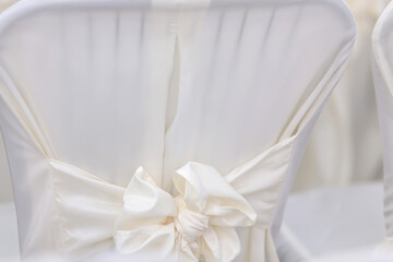 Luxurious texture of white chairs with a bow
