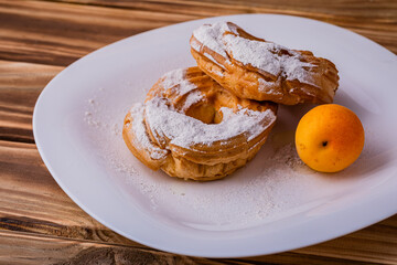 Ruffin custard ring with cottage cheese cream and apricots on a plate. Great dessert for Breakfast.