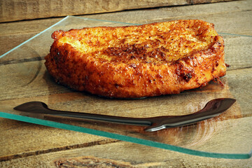 Typical French toast in plate on wood