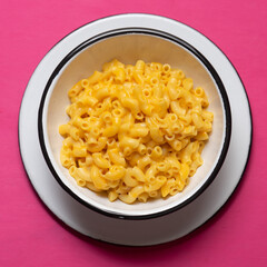 Creamy mac and cheese on pink background