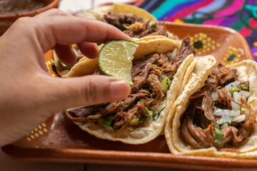 Mexican slow cooked lamb tacos also called barbacoa on white background