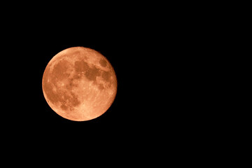 Red strawberry moon and black sky photographed on the 06.06.2020 in England