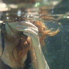 Redhead girl under the water. 
