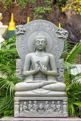 KRABI, THAILAND - 21 MARCH 2018: Statue of a stone gray Buddha in the Temple of the Tiger Cave in the rock.