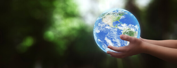 concept- boy holding planet earth in his hands- elements of this image furnished by NASA