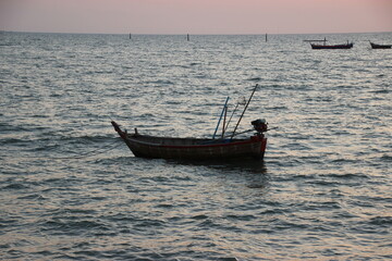 fishing boats in the sea and sunset