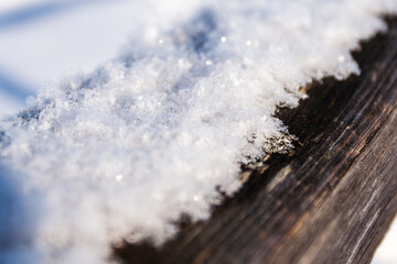 Frost snowflakes on wood, bridge with sun and snow