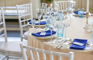 table set for a wedding reception with a blue accent