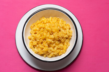 Creamy mac and cheese on pink background