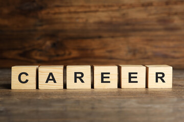 Cubes with word CAREER on wooden table. Space for text