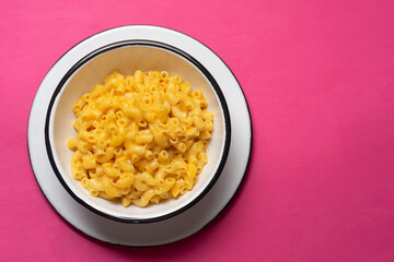 Creamy mac and cheese on pink background