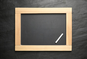 Empty blackboard with chalk on slate background, top view. Space for text