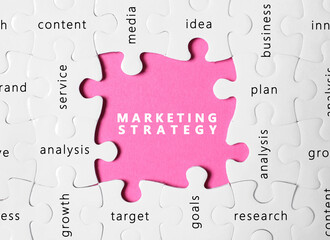Business concept. White puzzle pieces with different phrases on pink background, top view
