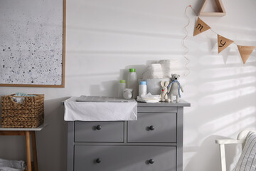 Chest of drawers with changing place in baby room. Interior design