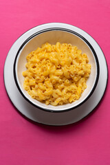 Creamy mac and cheese on pink background