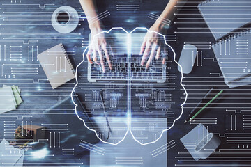 Double exposure of woman working on computer andhuman brain hologram drawing. Top View. Ai concept.