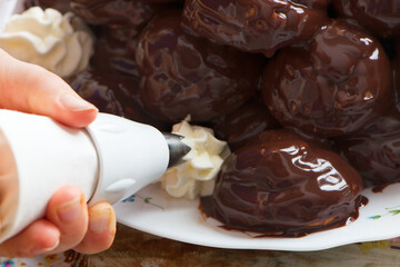  filling cream with pastry bag in a profiterole