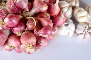 A group of garlic and red onion on white background