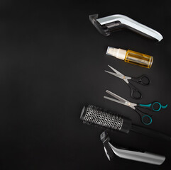 Barber tools for cutting and styling on a black background.