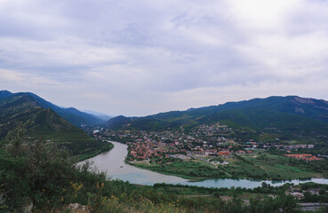 Fototapeta na wymiar Confluence of two rivers Kura and Aragvi. Mtskheta, an ancient city of Georgia. Travel to the sights of the Caucasus.