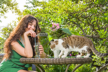 Young woman with cat at backyard
