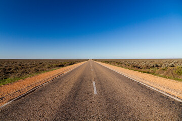 Fototapeta na wymiar A lonely straight highway on the Nullarbor, South Australia