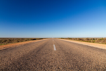 Fototapeta na wymiar A lonely straight highway on the Nullarbor, South Australia