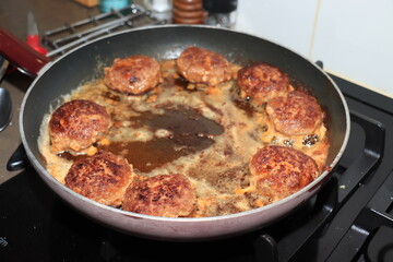 Frying meatballs in pan
