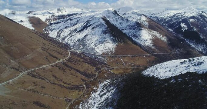 aerial view and moving shot of beautiful landscape of mountain v-shaped vally scenery shot of nature mountain with winding road in Siguniang, Sichuan province, Western China
