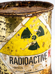 Radiation warning sign on the rusty and decay radioactive material container