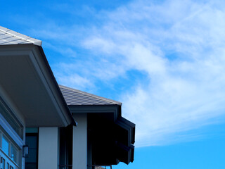 House with blue sky background.Copy Space.Slate roof and slope with clouds and blue sky background.Tile roof of construction house with blue sky and cloud background.