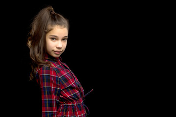 Close-up.Portrait of a cute little girl on a black background.
